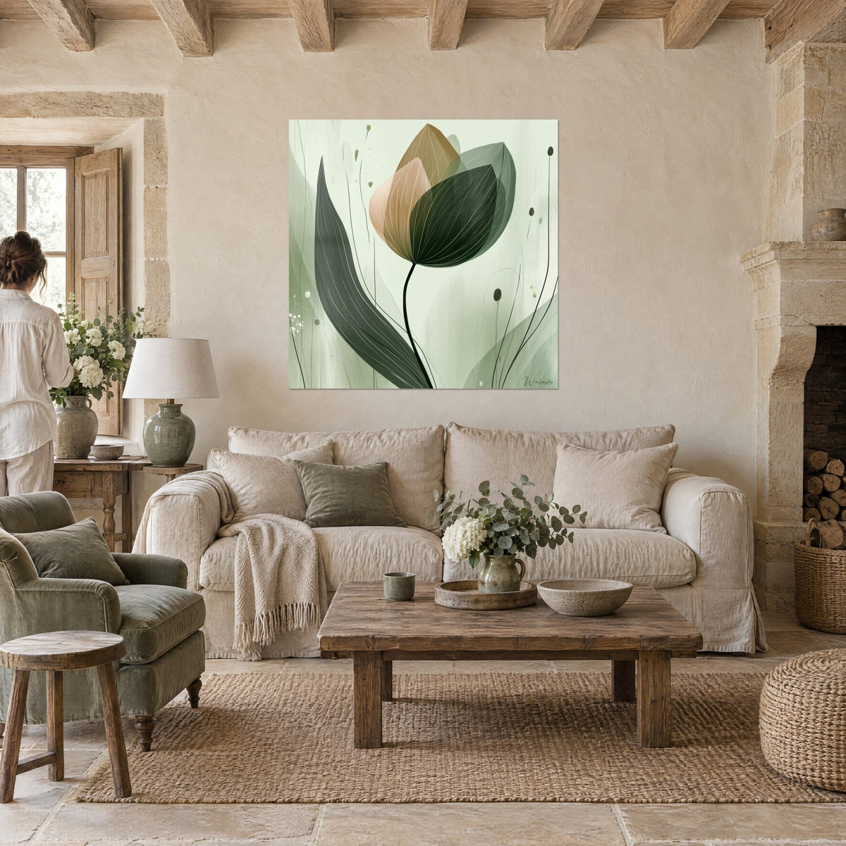 Wall art of a stylized tulip with blush beige and sage green petals, long forest green leaf, above a sofa in a bright living room