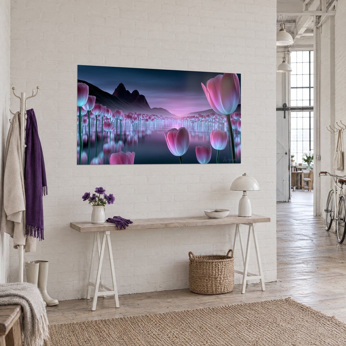 Wall art close-up of vivid pink and turquoise tulip blooms on a mirror-like lake, black peaks in the distance, hung in a white artist's loft