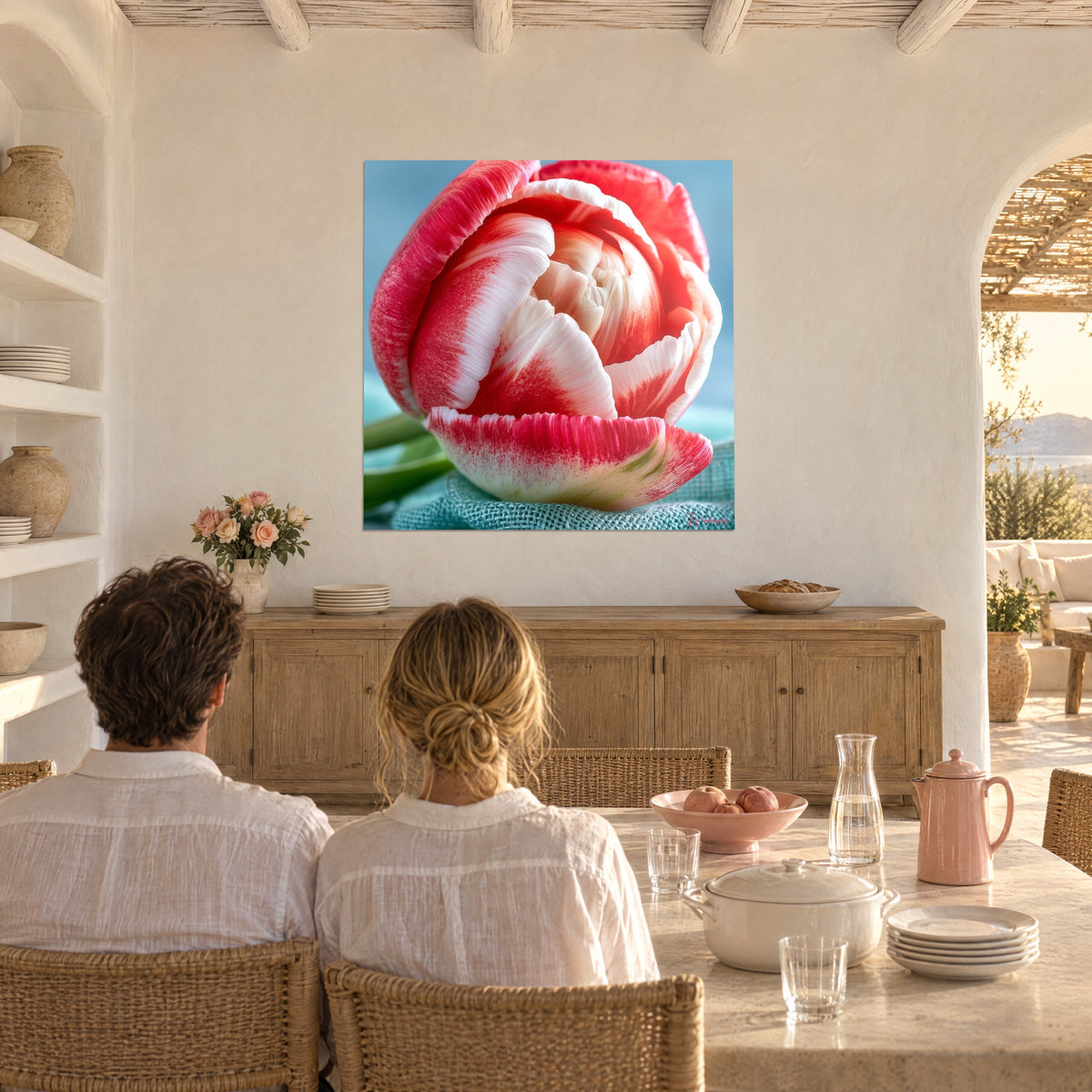 Wall art tulip variegated in vivid pink and pearlescent white, heart of curled petals on a pale blue background, couple at a table in a vaulted hall
