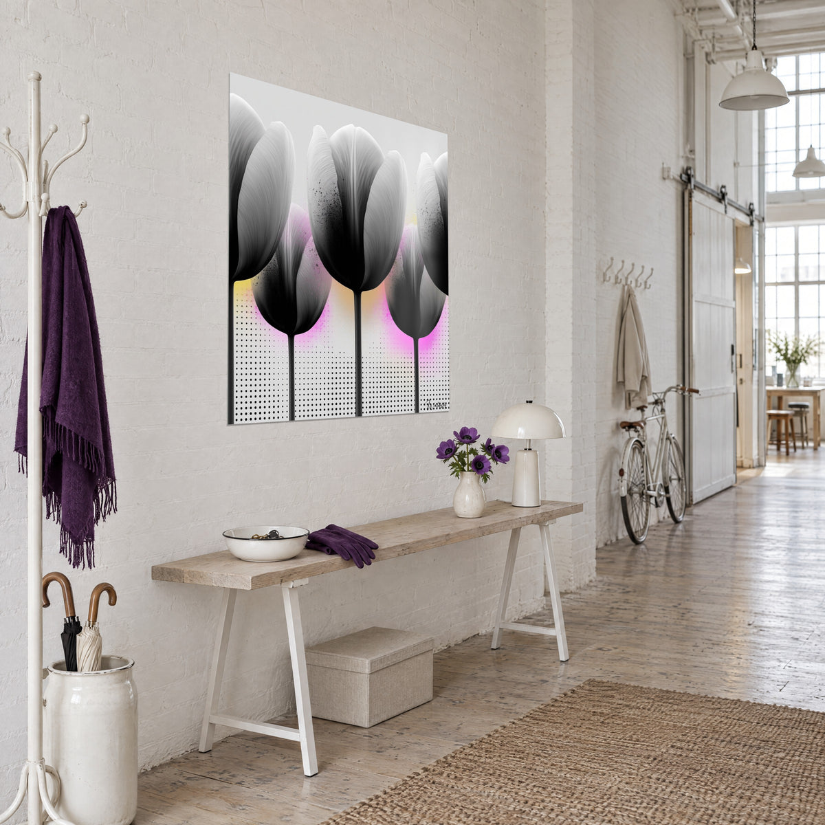 Wall art of four tulip blooms in anthracite gradient, slender black stems, fuchsia pink glow, three-quarter view beside a white coat stand in a loft