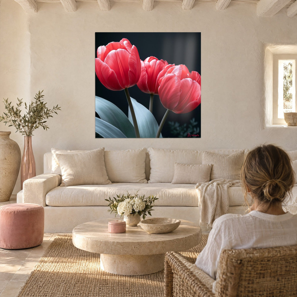 Wall art three coral pink tulips on an anthracite background, grey-green leaves, above a sofa in a bright living room