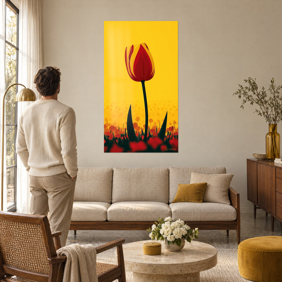 Wall art vermilion tulip striped with yellow on a mustard background, a man seen from behind admires it above a sofa in a bright living room