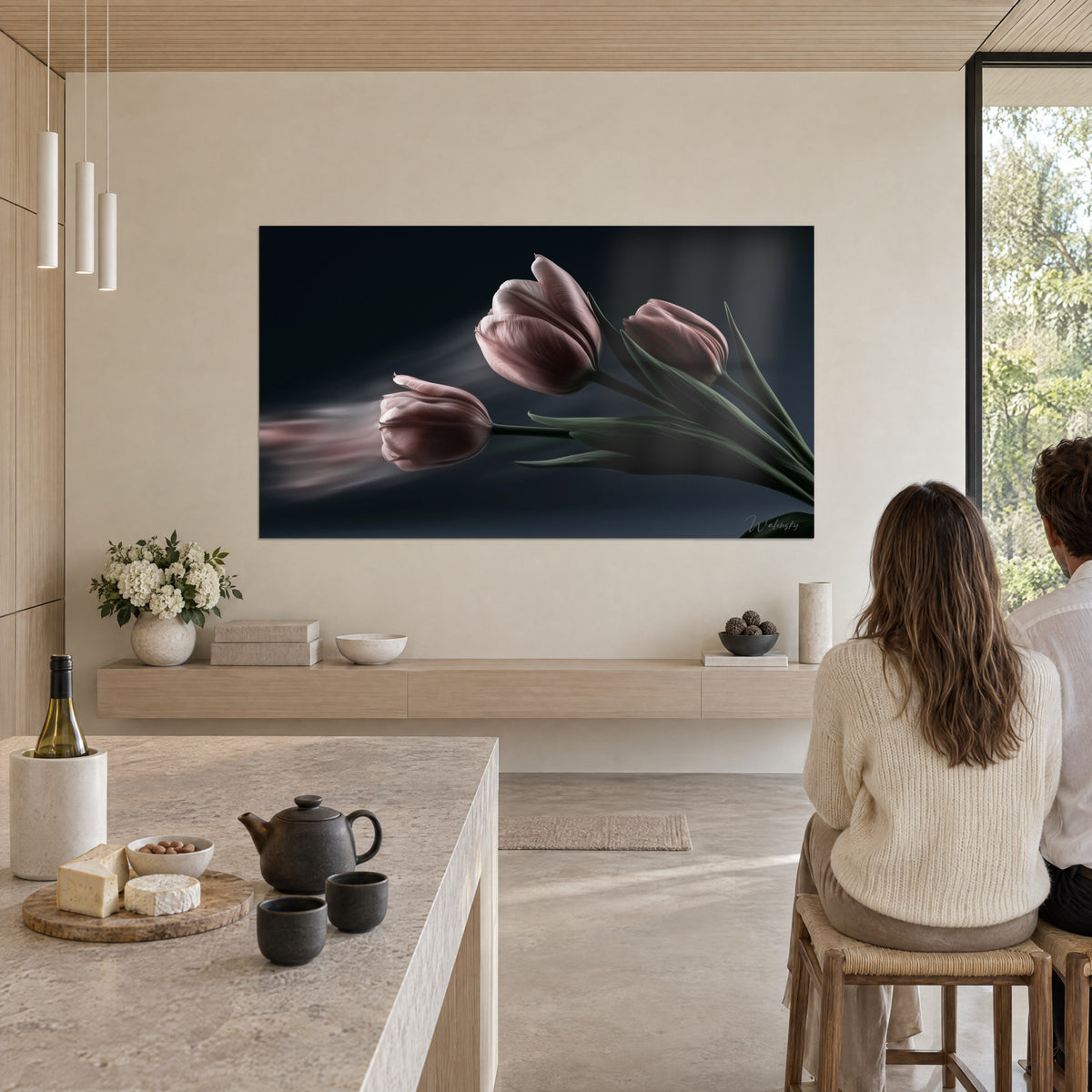 Tableau corolles de tulipes rose antique sur noir bleuté, longues feuilles sombres, deux personnes de dos près d'un îlot de cuisine en pierre claire