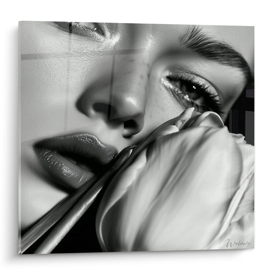 Visage féminin en noir et blanc frôlant un pétale de tulipe blanc soyeux