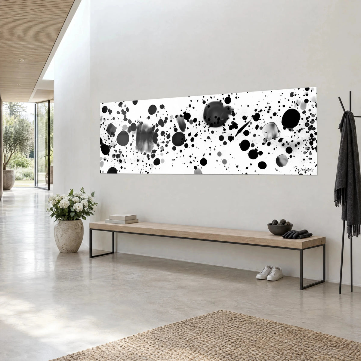 Wall art with black droplets on pure white background, blurred grey spots in transparency, angled view, light wooden bench