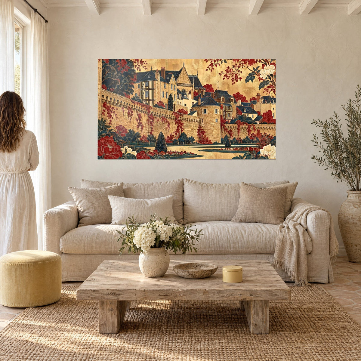 Wall art golden ramparts of Vannes, red Virginia creeper and cream peonies, a woman seen from behind, above a sofa in a bright living room