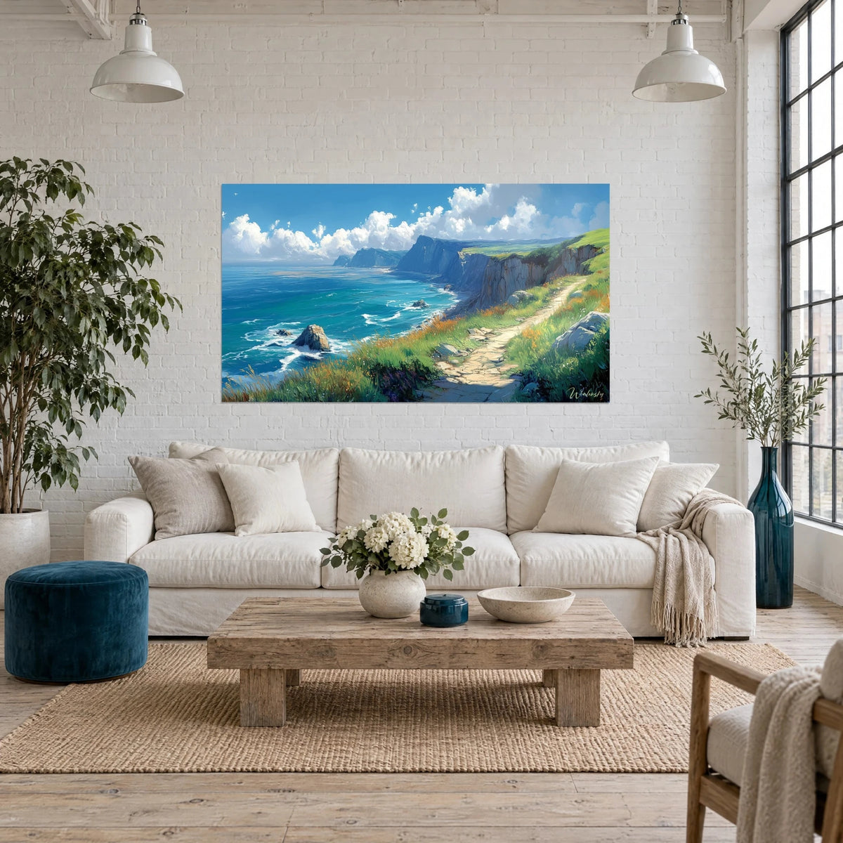 Gemälde Klippen am türkisfarbenen Ozean, Steinpfad und grünes Gras, über einem Sofa in einem hellen Wohnzimmer