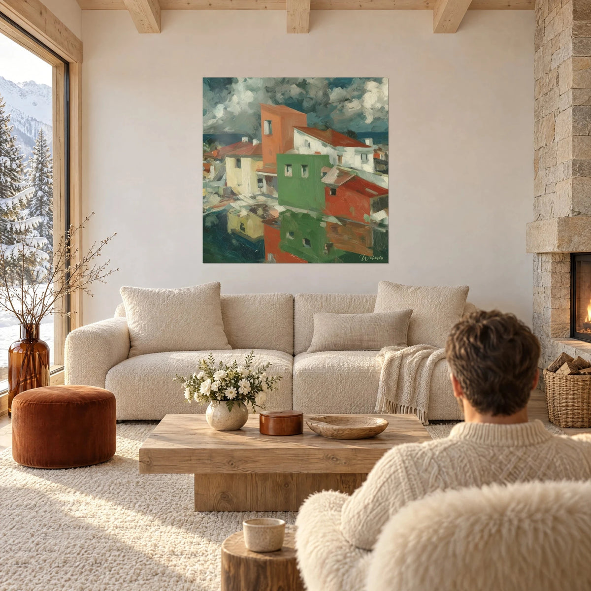 Gemälde Dorf mit roten Dächern unter grauen Wolken, grüne Fassade und orange Wand, über einem Sofa in einem hellen Wohnzimmer