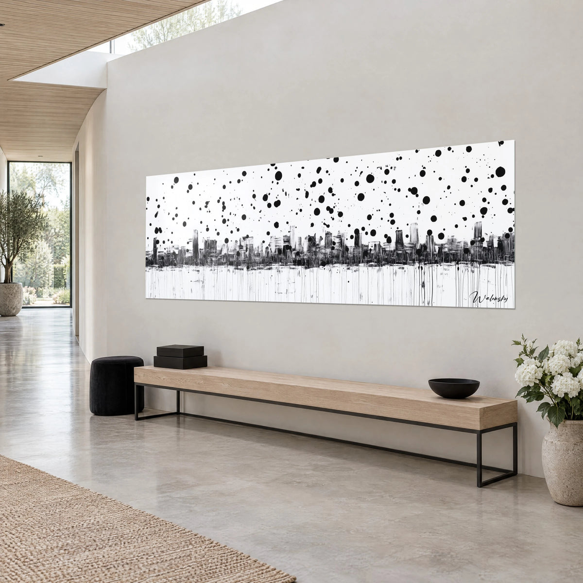 Wall art sketched skyscraper silhouettes with dry brush, black ink drops on bright white, grey wall and light wooden bench