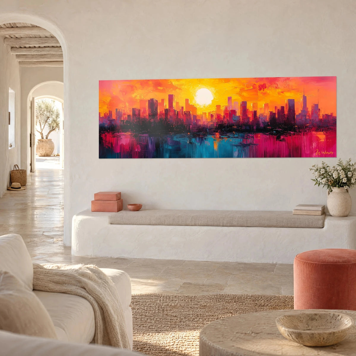 Wall art of skyscrapers in violet and red silhouettes, pale sun over an amber sky, turquoise water, whitewashed wall, stone bench