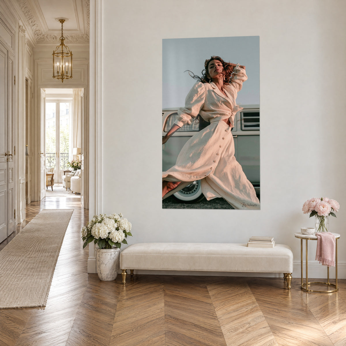 Wall art of a dancer in a knotted blouse and ivory button-front skirt, grey-blue sky and vintage van, in a Haussmann-style corridor