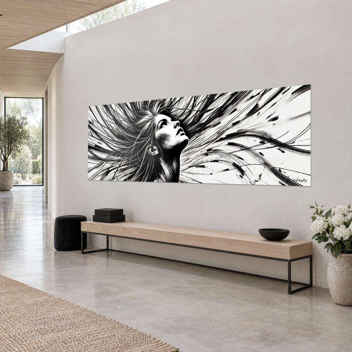 Wall art female portrait in black ink, flyaway strands drawn in fine lines and a visible earring, against the light grey wall of an architect's house