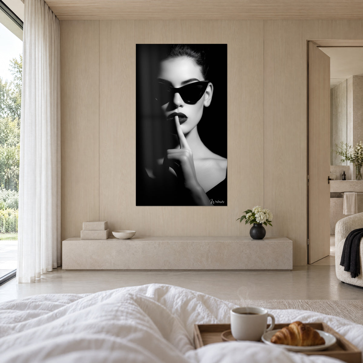 Cuadro gesto de silencio, gafas negras de ojo de gato, tez blanca radiante sobre fondo de ébano, encima de una cama en un dormitorio luminoso