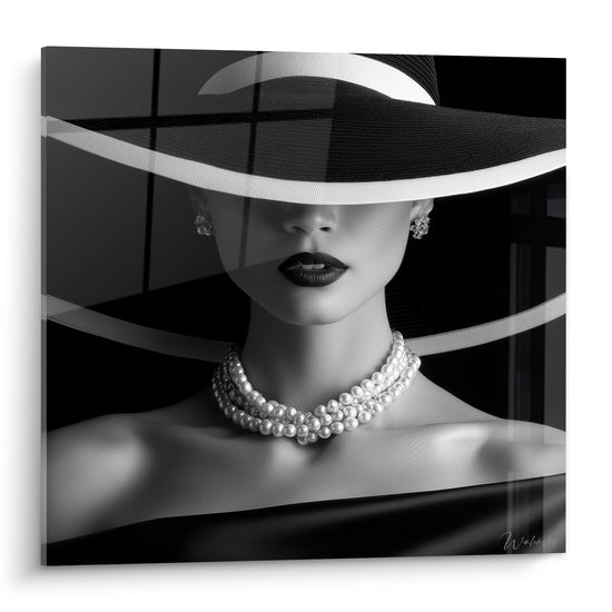 Visage noir et blanc sous chapeau noir, lèvres sombres, collier de perles blanches nacrées éclatant