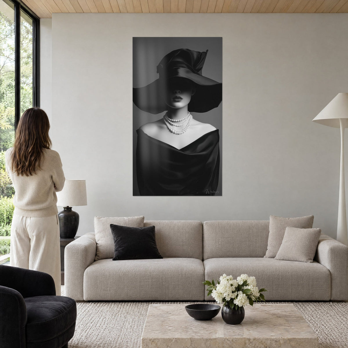 Gemälde Porträt einer Frau mit breitem Hut aus schwarzem Satin, Perlenkette, über einem Sofa in einem hellen Wohnzimmer