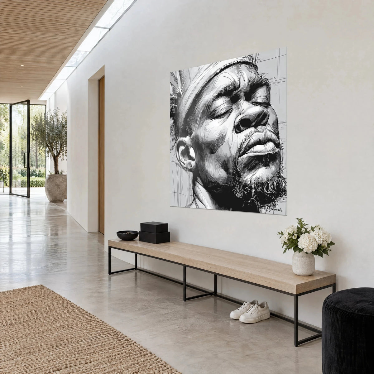 Cuadro rostro sereno, boceto en blanco y negro, barba rizada y labios carnosos, sobre una pared marfil de entrada en vista de tres cuartos