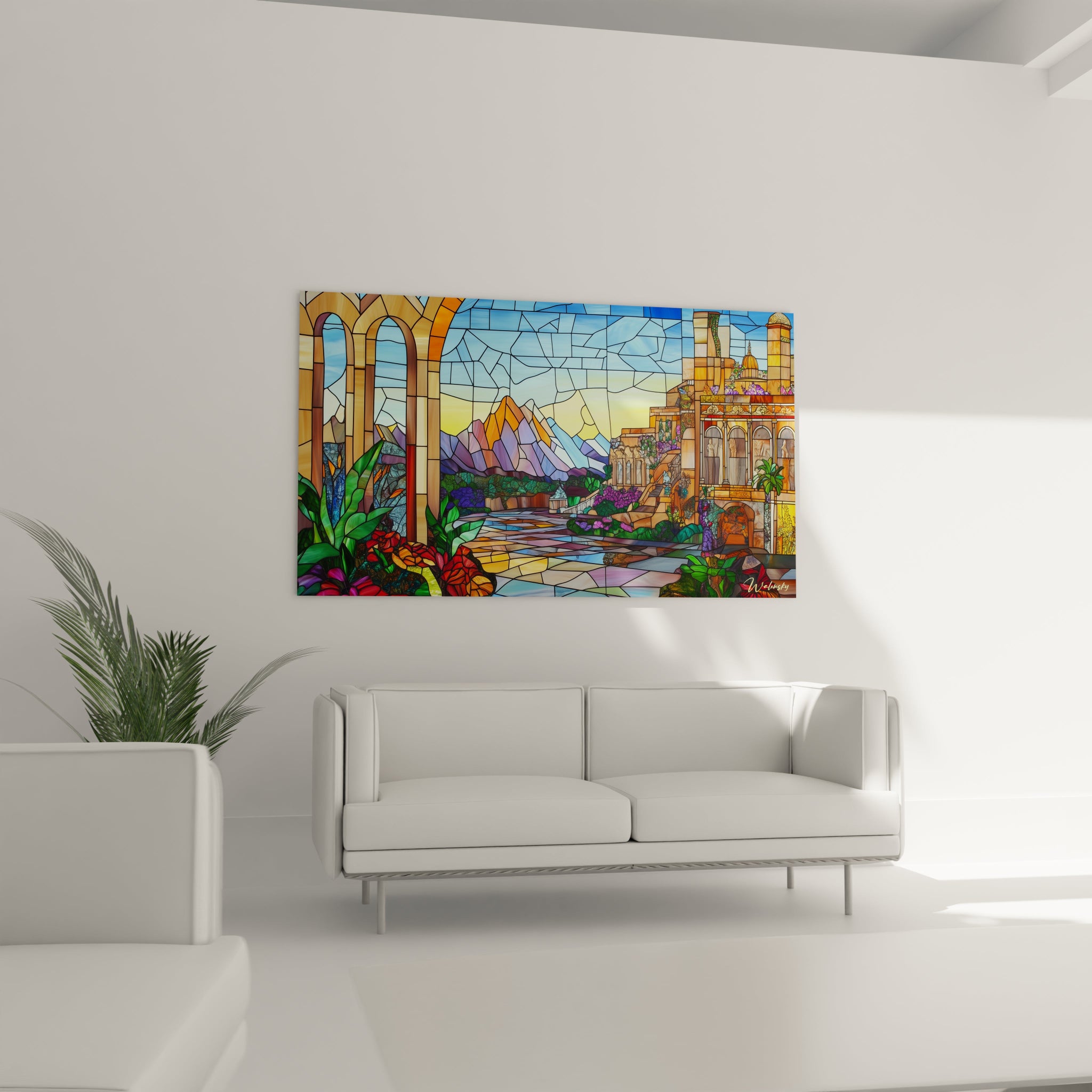 Un tableau vitraux paysage combinant des éléments architecturaux ocre et beige, une végétation verte éclatante, des montagnes violettes et orangées, et un ciel bleu intense, le tout fragmenté en sections géométriques créant l'effet caractéristique d'un vitrail illuminé.
