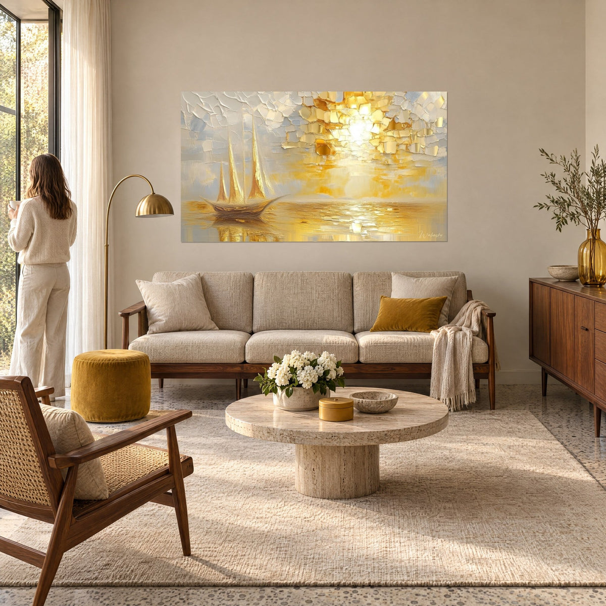 Wall art three-masted ship with golden sails on shimmering sea, pearl-grey sky in thick impasto strokes, above a sofa in a bright living room