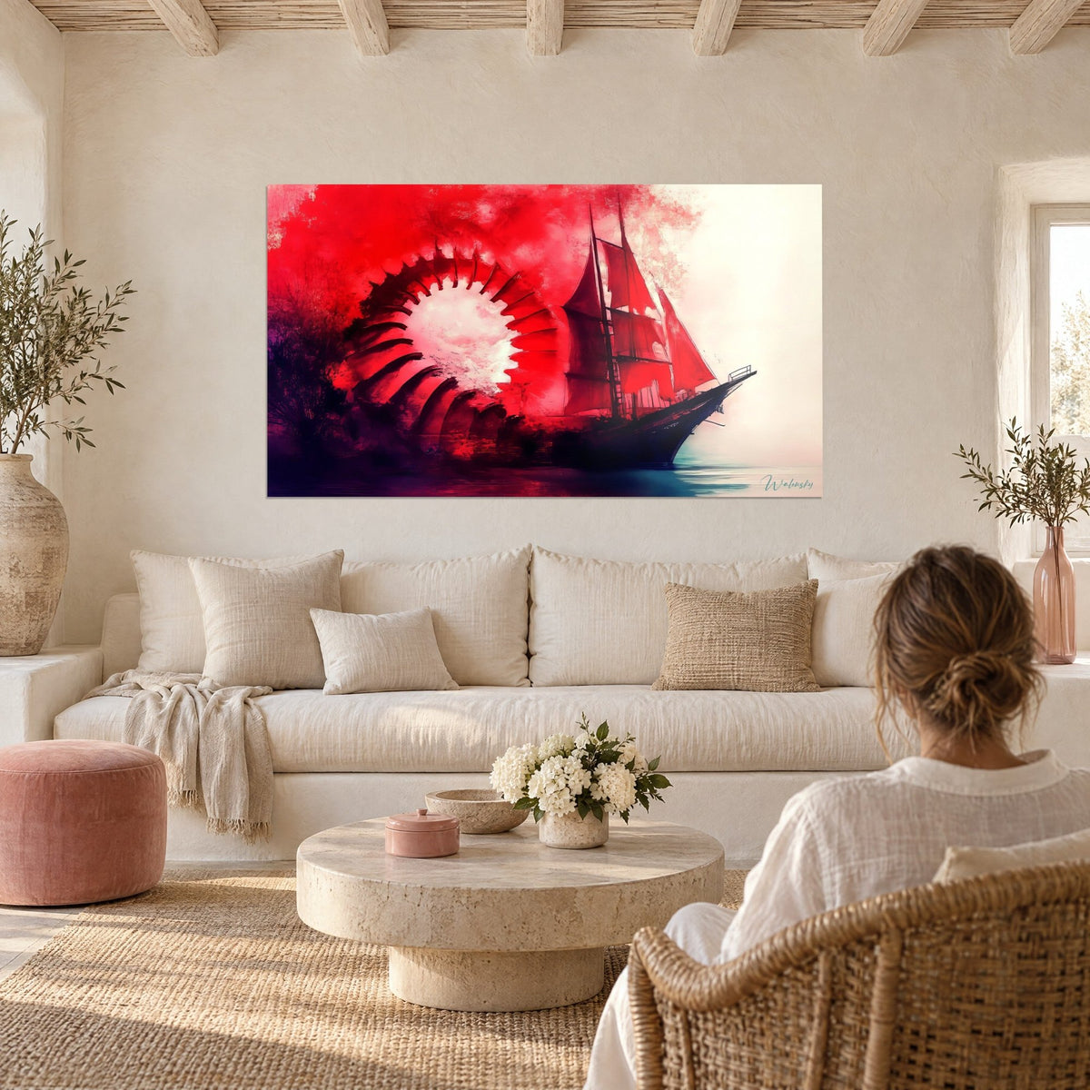 Wall art three-masted ship with scarlet sails, red and cream spiral, woman seen from behind, above a sofa in a bright living room