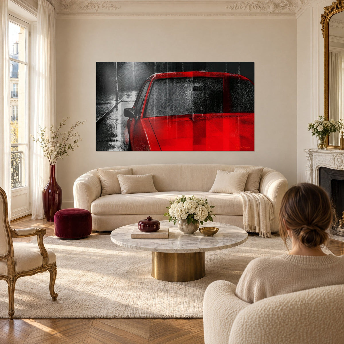 Wall art of a bright red sedan under a downpour, glossy grey pavement and a street lamp in a halo, above a sofa in a bright living room