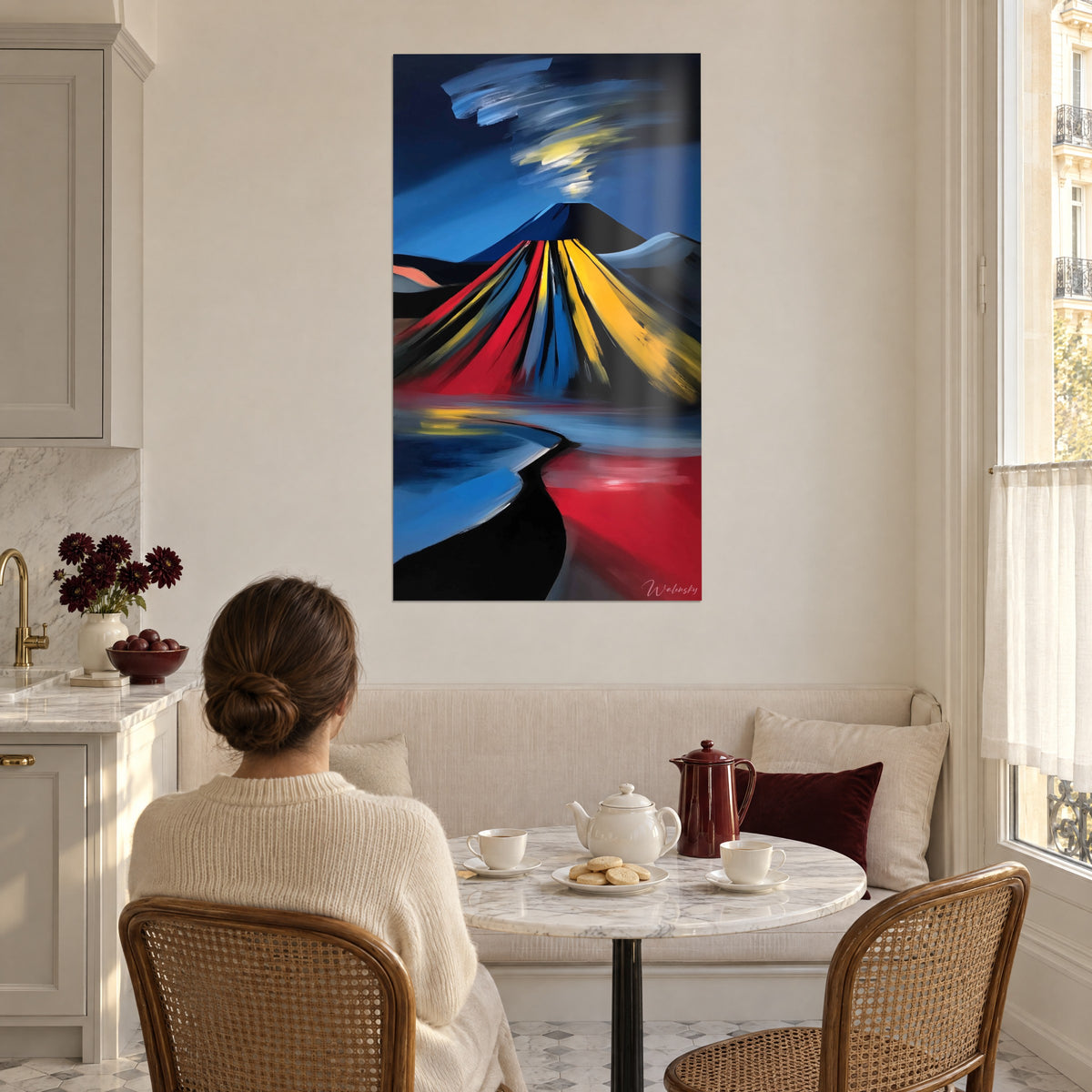 Wall art smoking crater with broad red and blue brushstrokes, woman seen from behind before her cup in a bright kitchen