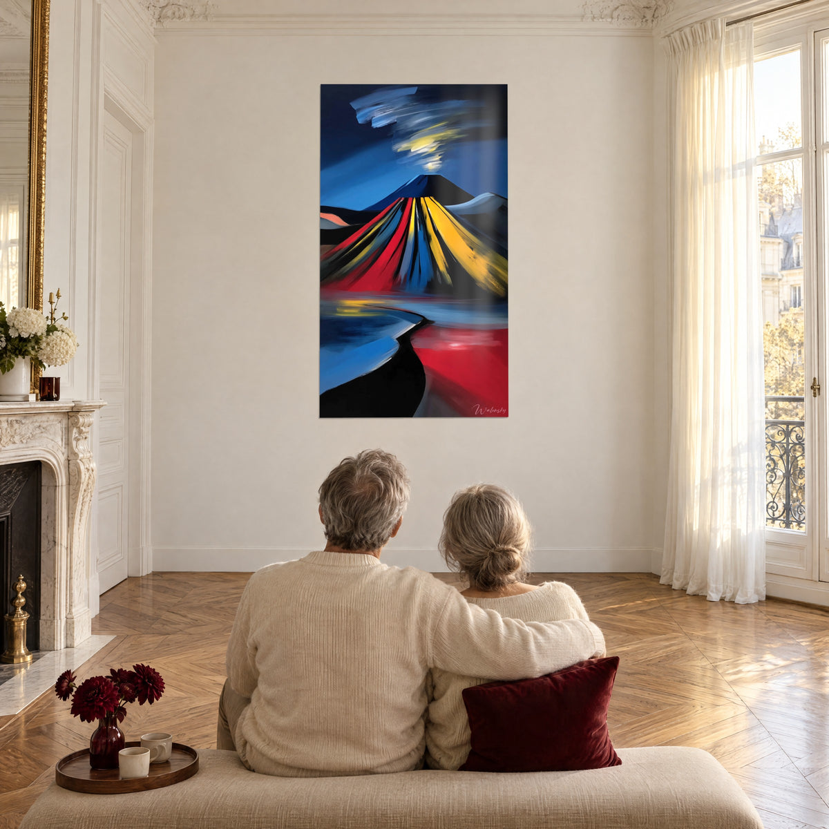 Wall art stylized Mount Fuji with sunny yellow and blood-red stripes, couple seen from behind seated facing it in a large living room