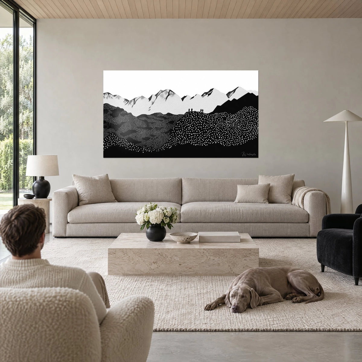 Wall art snow-capped mountain range in black and white dots, small roped party on the ridge, above a sofa in a bright living room