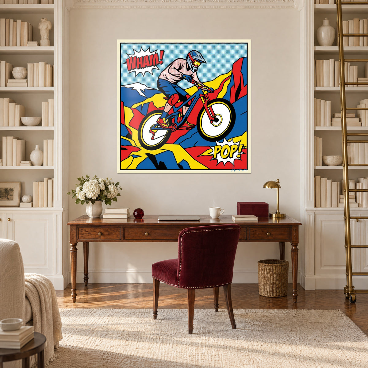 Cuadro de bici de montaña pop art saltando sobre picos rojos, azules y amarillos, gran globo WHAM!, pared blanca entre dos estanterías y un escritorio de madera