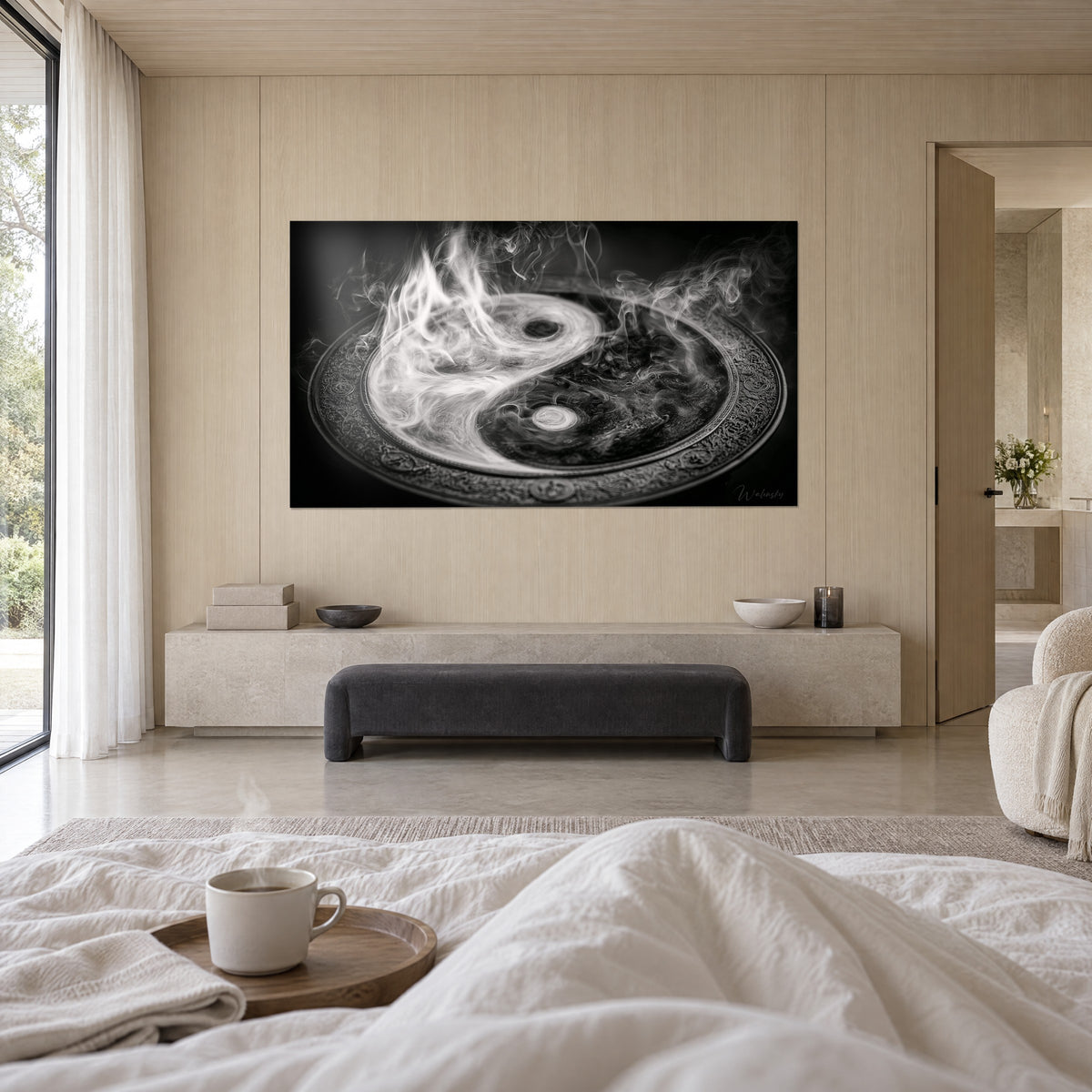 Wall art chased metal disc with silver and black smoke, beige wall, anthracite bench, cup on a tray, above a bed in a bright bedroom