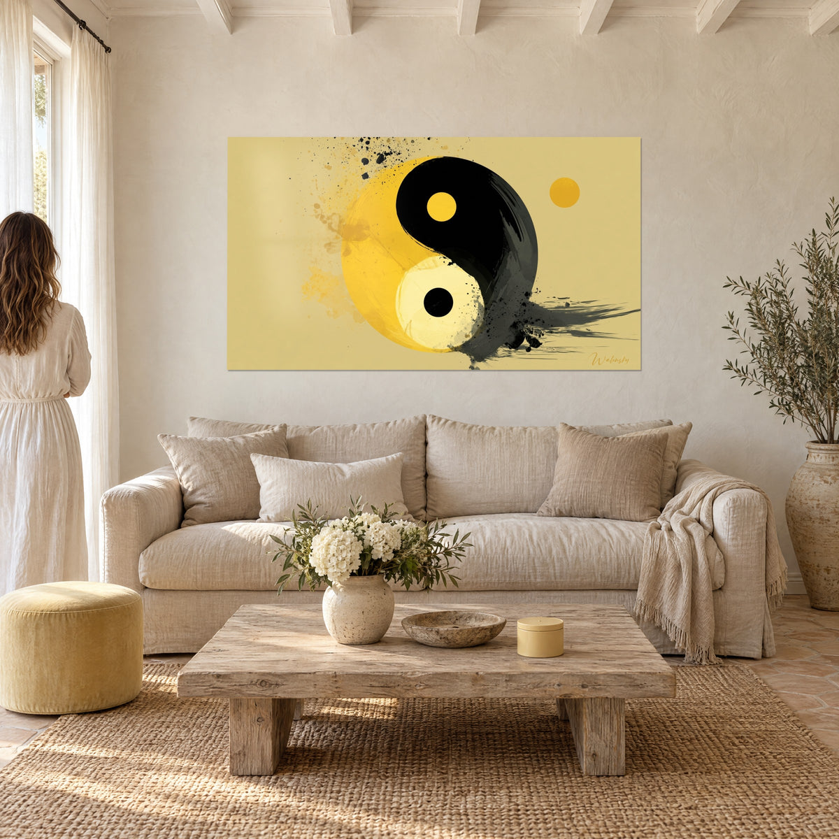 Wall art yin yang in sunny yellow and black, ink splashes on sand background, hung above a sofa in a bright living room