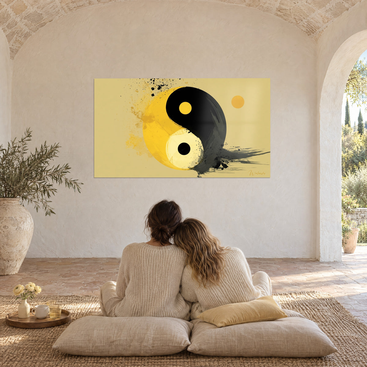 Wall art Taoist emblem with black ink splatters on straw background, admired by a couple seen from behind beneath the vaulted ceilings of a farmhouse