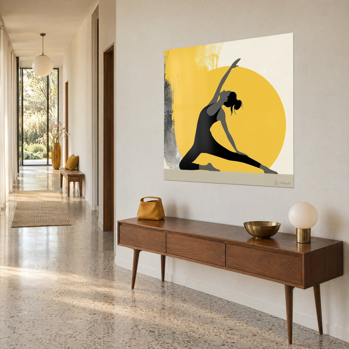 Wall art stretching yogi, raised arm, black and grey in front of a large yellow circle, hung above a wooden sideboard in a hallway