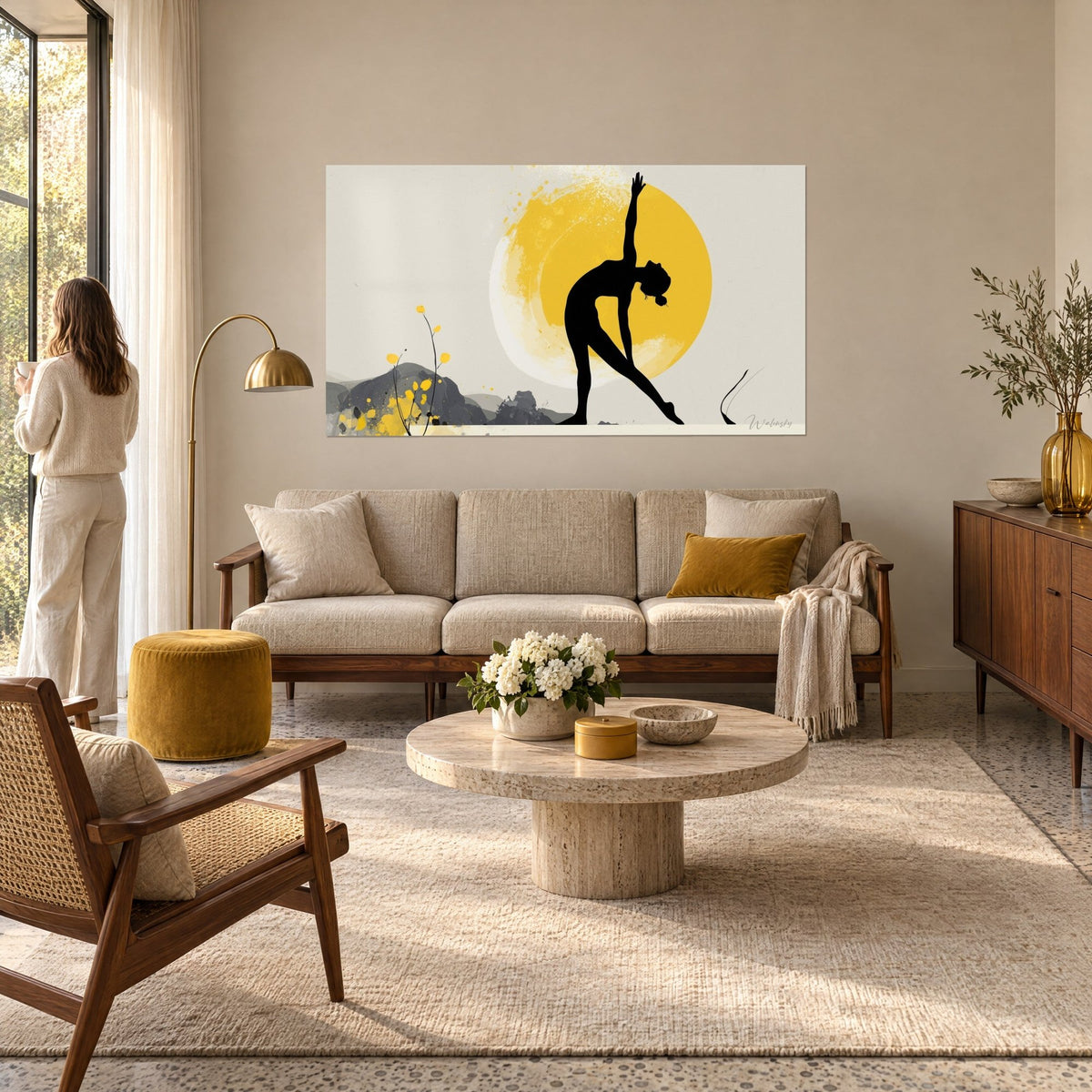 Wall art black silhouette in a side stretch in front of a saffron-yellow sun, cream background, above a sofa in a bright living room