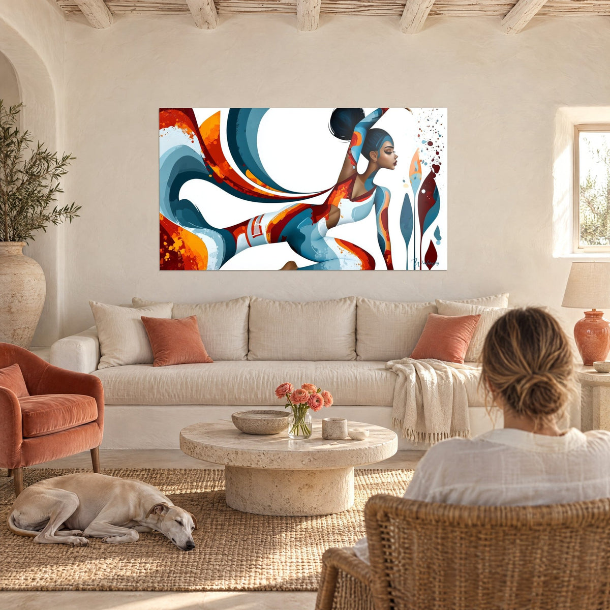 Wall art yoga dancer in petrol blue and burnt orange, black bun, raised arm, above a sofa in a bright living room