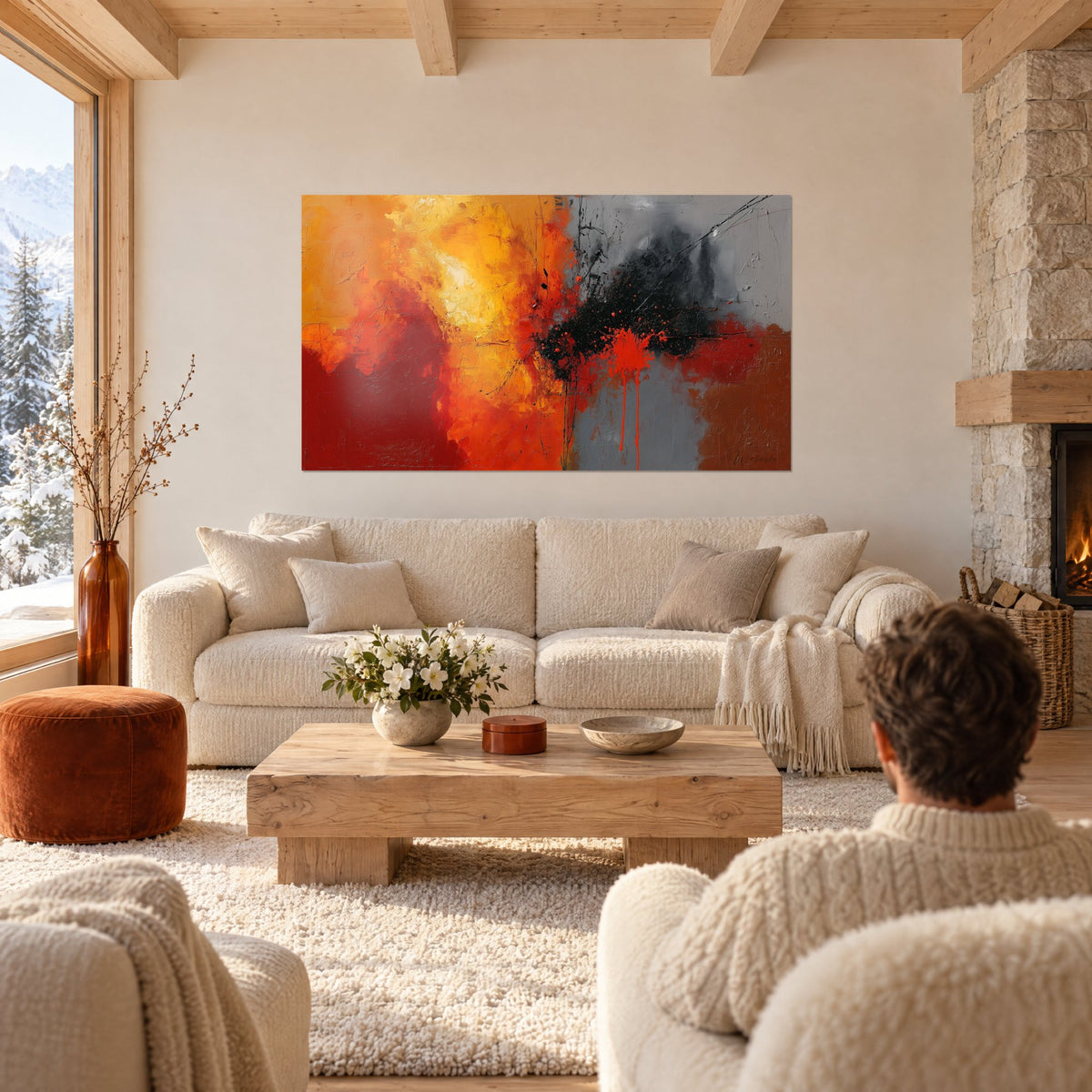 Tableau explosion de rouge et d'orange éclaboussée de noir, au-dessus d'un canapé dans un salon lumineux