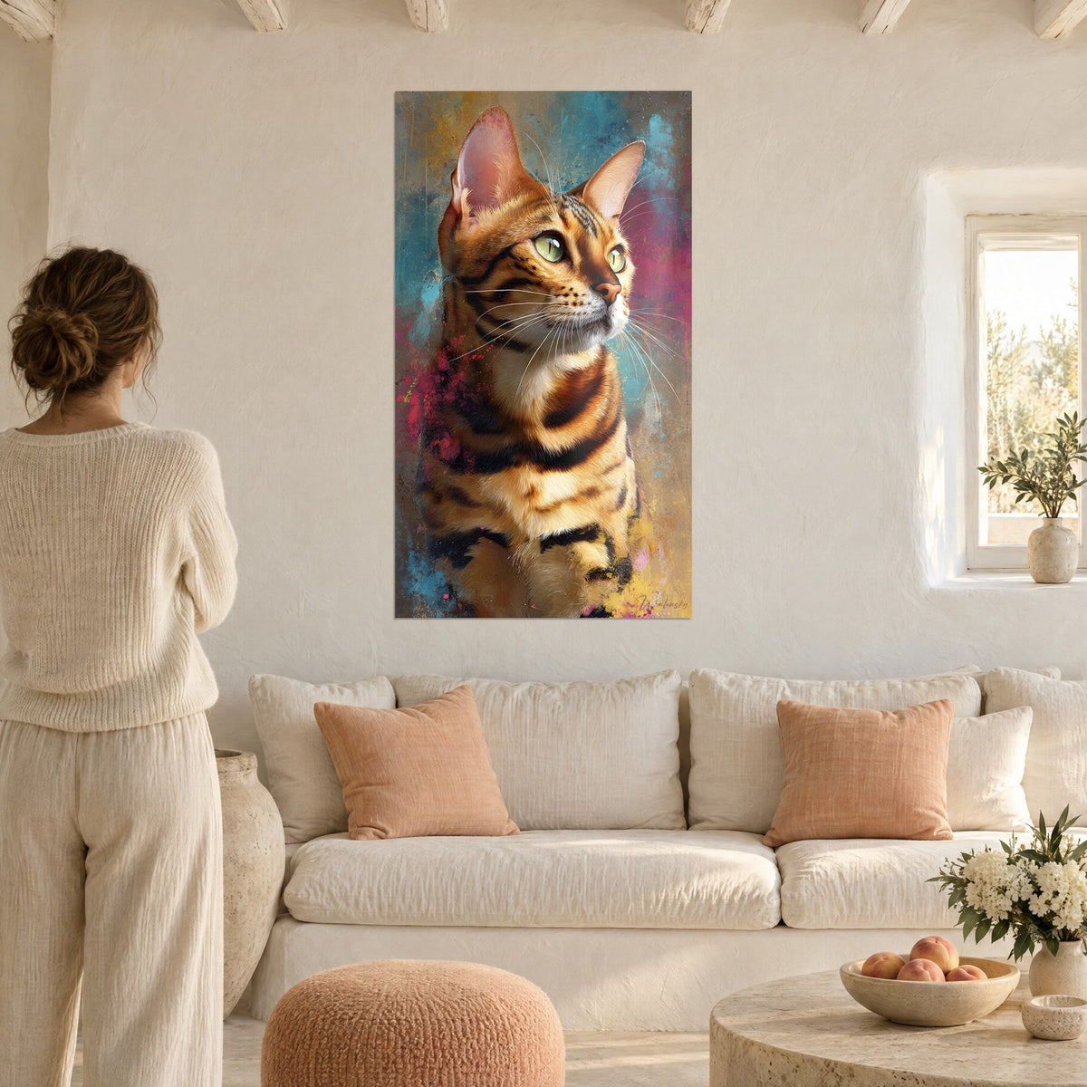Wall art Bengal cat with amber coat striped in black, fuchsia and turquoise splashes, a woman seen from behind above a sofa in a bright living room