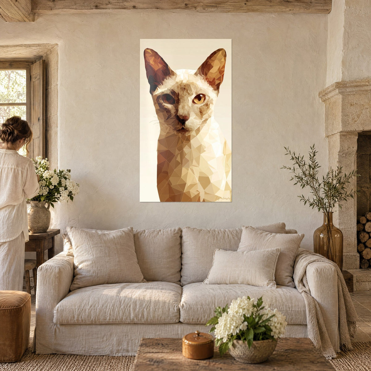 Wall art Singapura cat portrait in ochre and brown facets, upright ears, amber eye, above a sofa in a bright living room