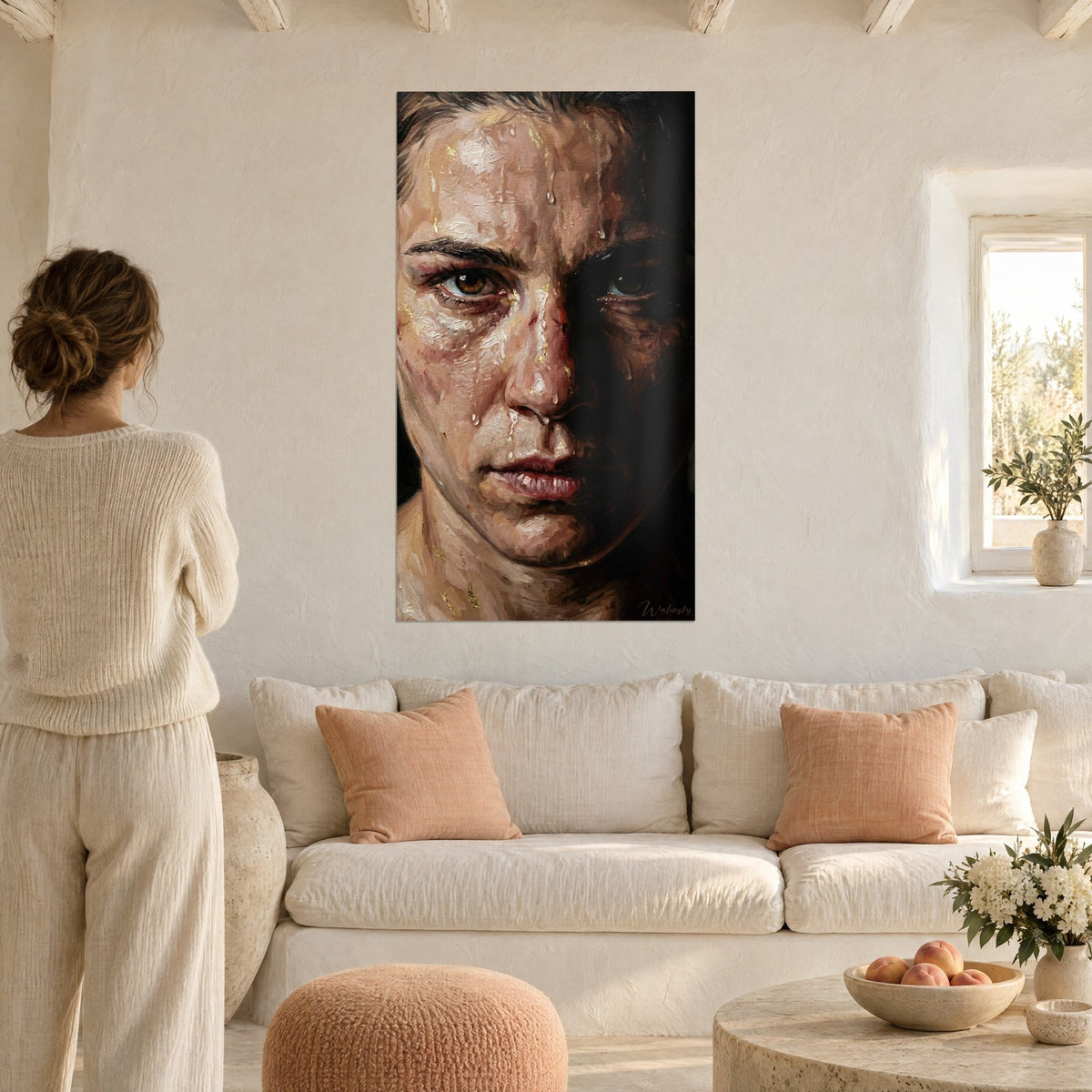 Wall art portrait of a fighter with amber eyes, face dripping with sweat and gold sparkles, woman seen from behind, above a sofa in a bright living room