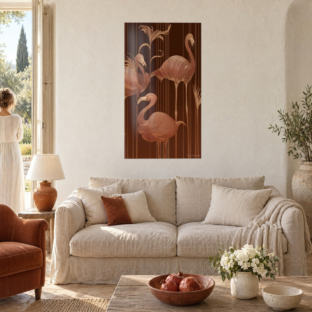 Wall art with three pink flamingos, their feathers drawn in fine copper lines on a chocolate brown background, above a sofa in a bright living room