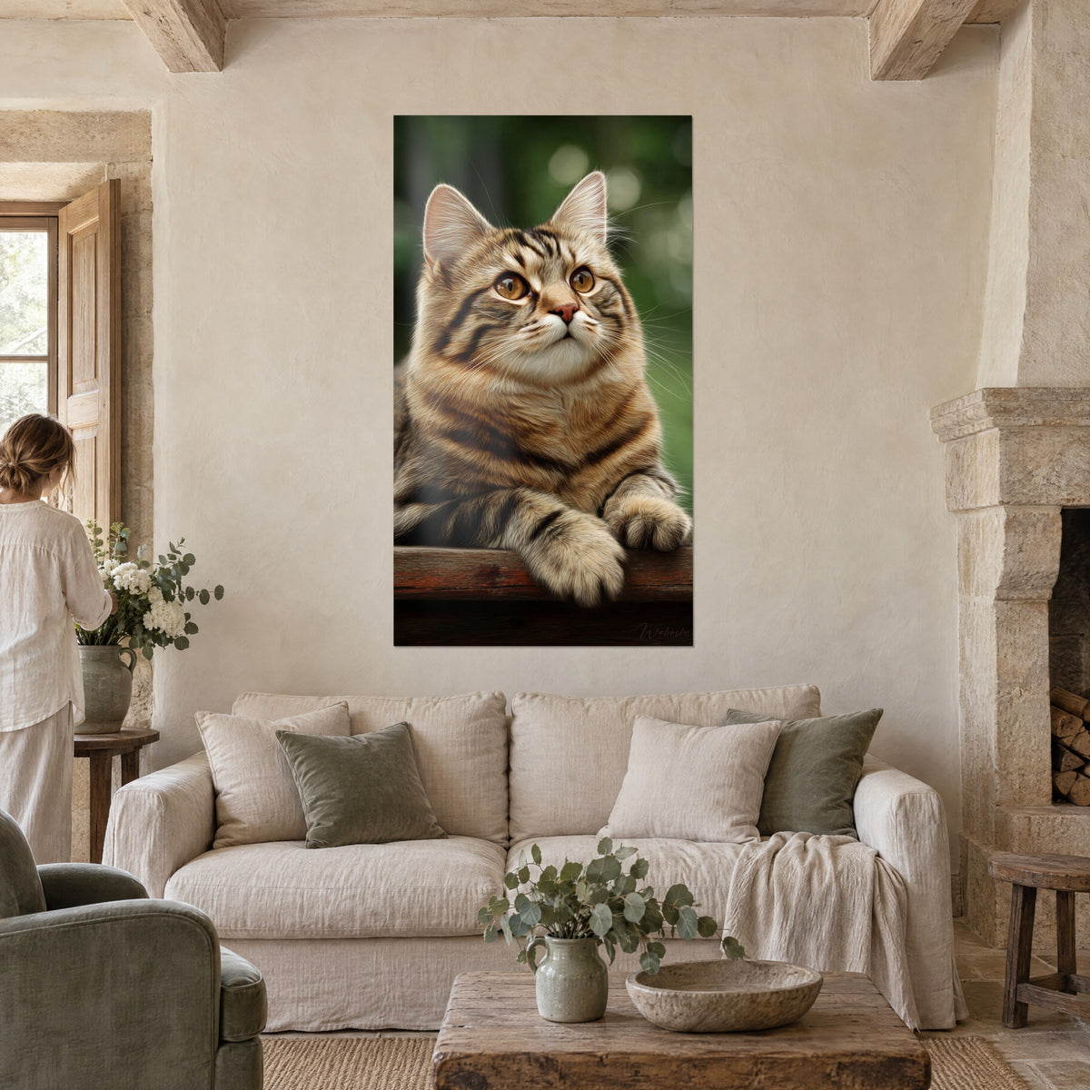 Wall art tabby cat with amber eyes, brown and cream coat, pink nose, sitting on a board, above a sofa in a bright living room