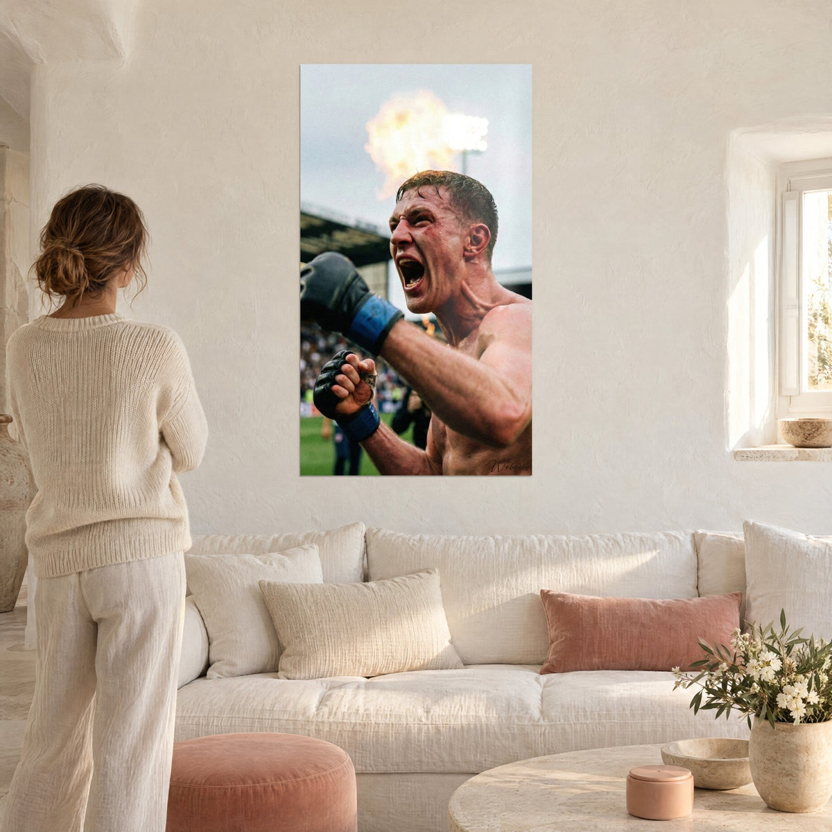 Wall art of an MMA fighter roaring his victory, black and blue gloves, orange flame, grey background, above a sofa in a bright living room