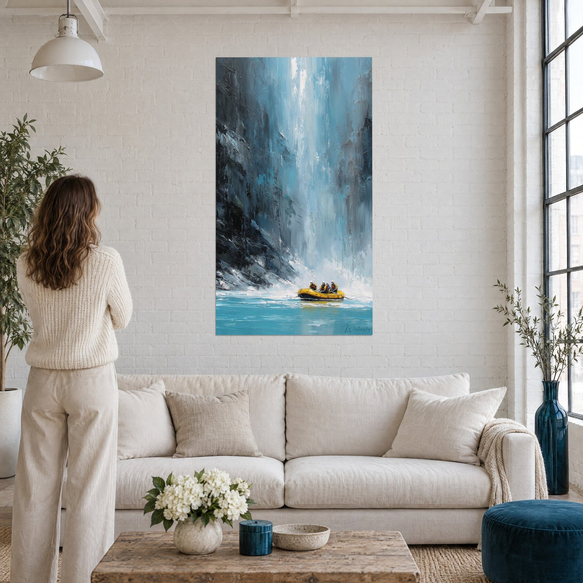 Wall art turquoise waterfall and anthracite cliff, yellow raft at the foot of the water wall, above a sofa in a bright living room