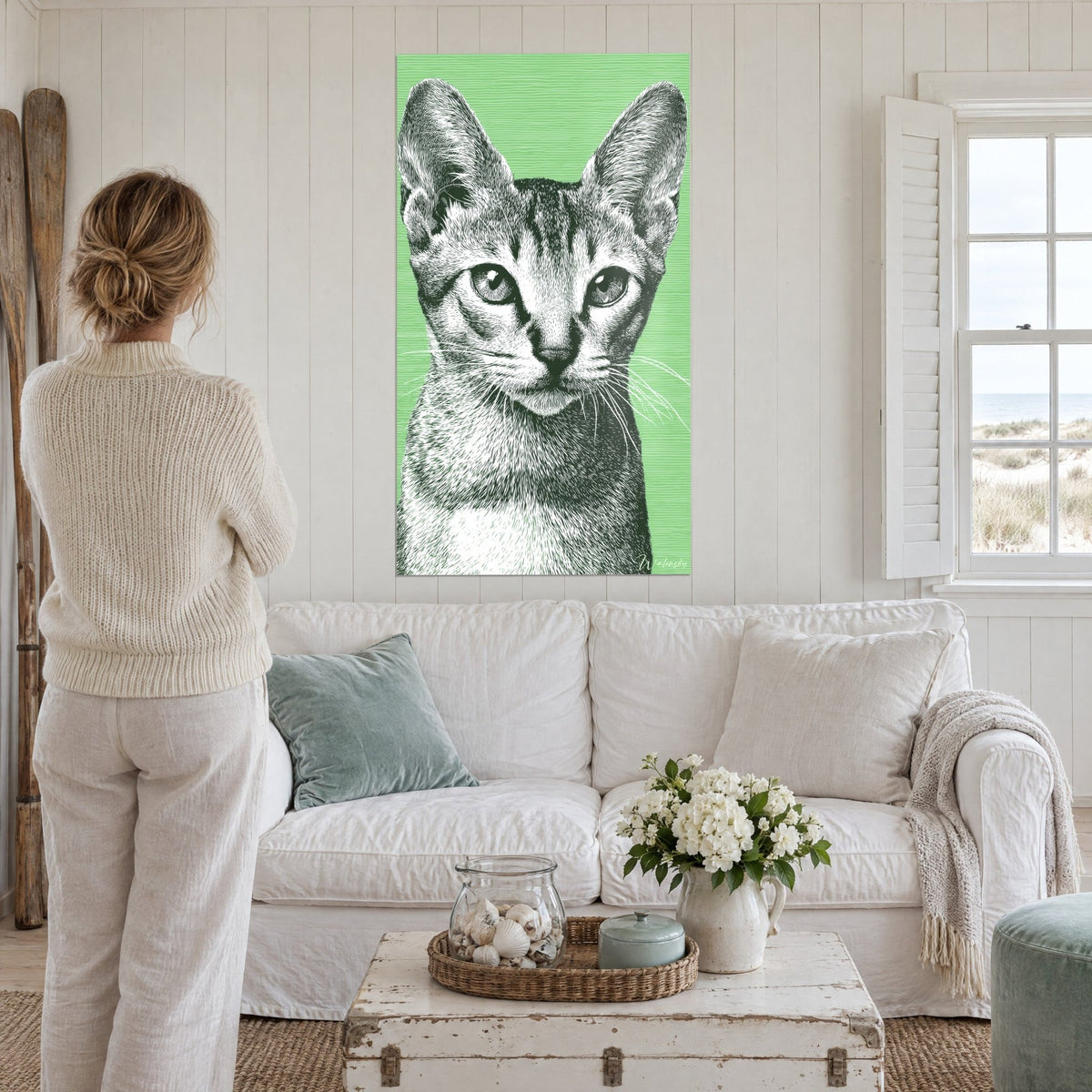 Quadro gattino Sokoke in incisione bianco e nero su fondo verde menta, orecchie grandi, sopra un divano in un soggiorno luminoso