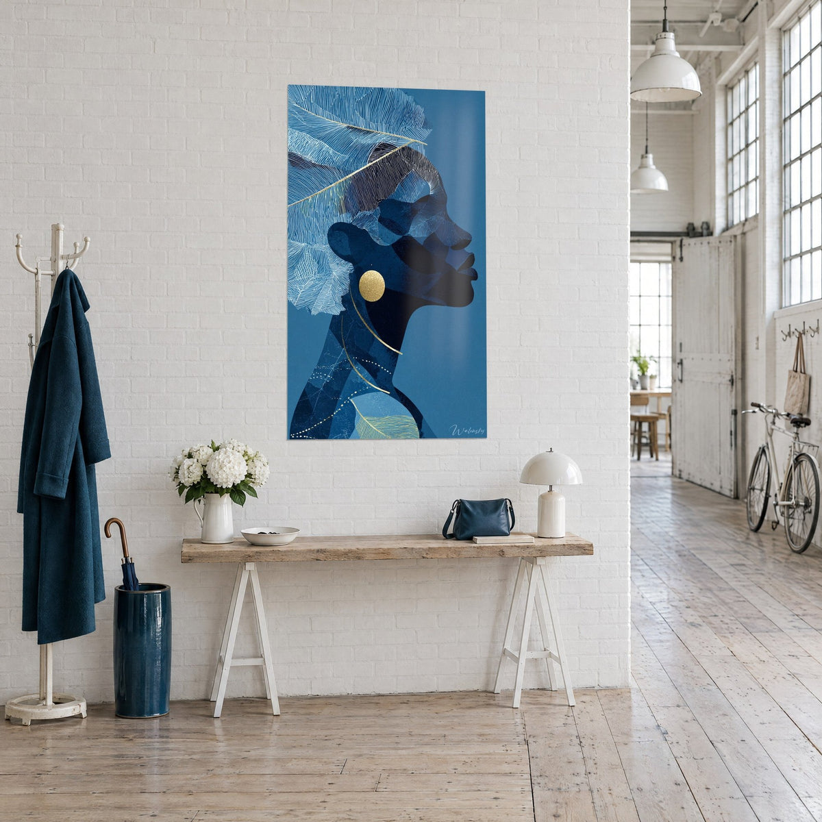 Wall art indigo female silhouette, sky-blue feathers with fine hatching and a gold ring, three-quarter view in a loft