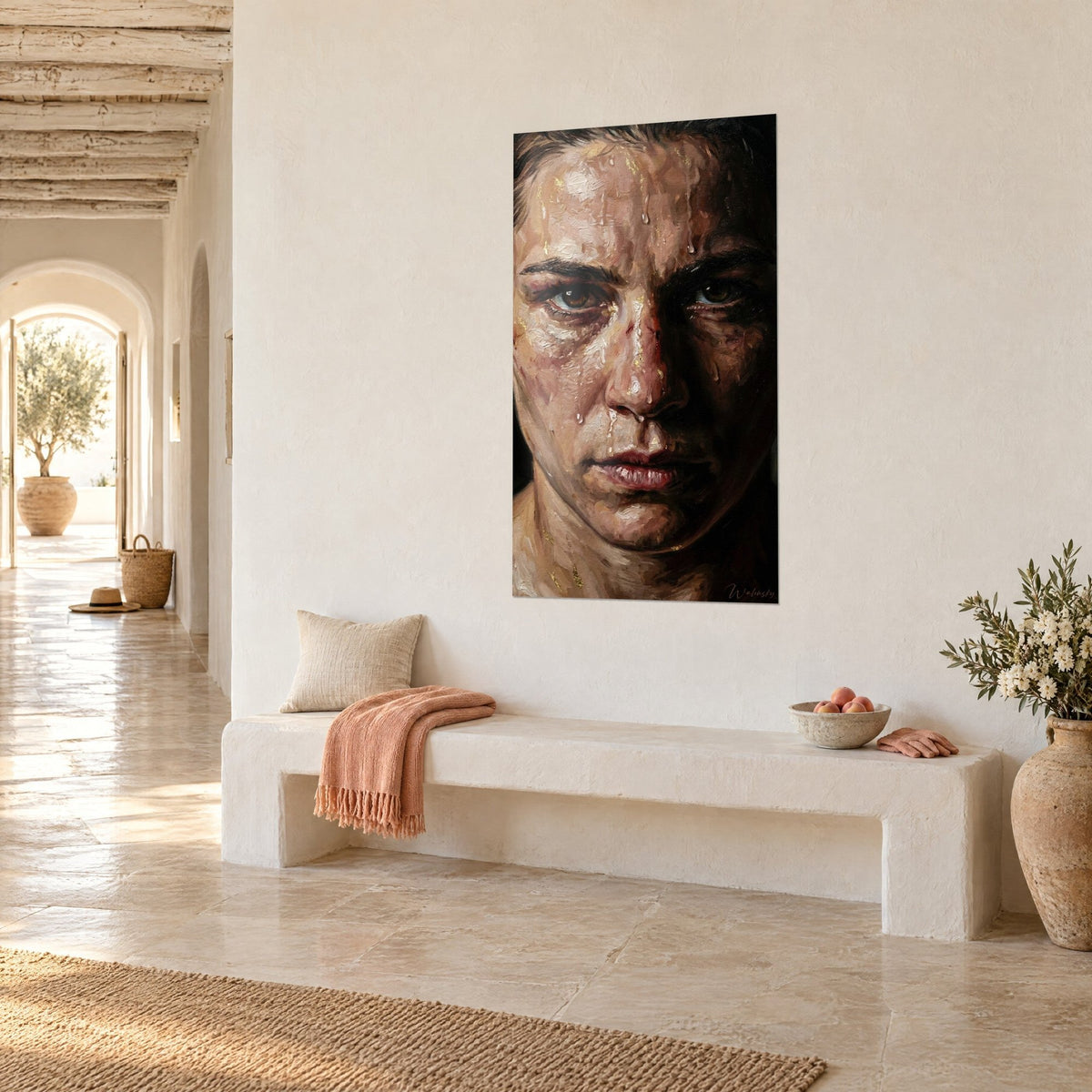 Wall art face of an athlete half lit, ochre and pink skin, black shadow on the right cheek, hung three-quarter view in a vaulted hallway