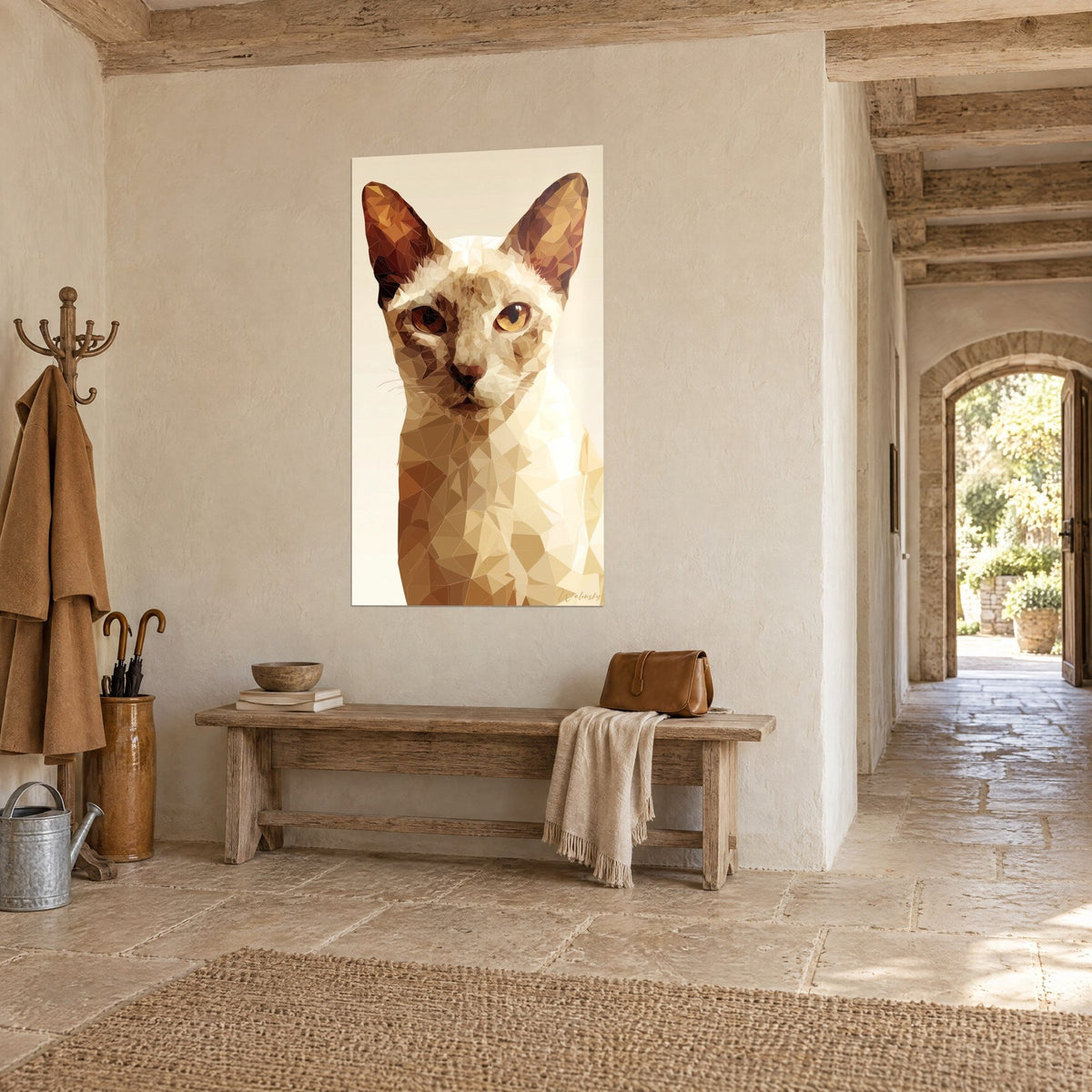 Wall art feline in cream with caramel and chocolate triangles, intense amber gaze, hung in a stone entrance above a wooden bench