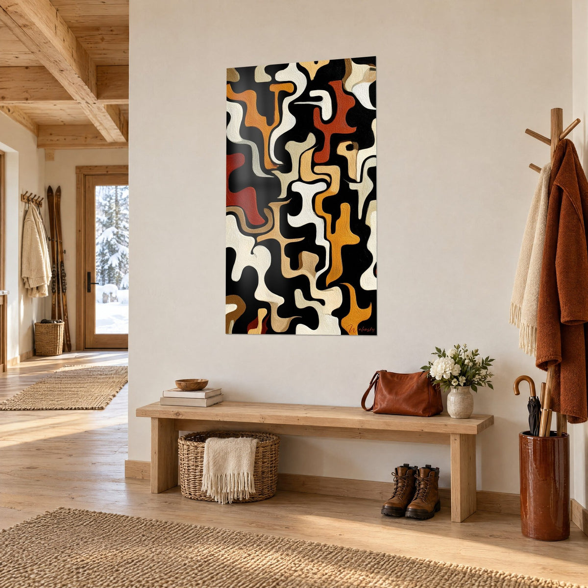 Schilderij met abstracte Afrikaanse kronkels in baksteenrood en mosterdgeel op een zwarte achtergrond, in de hal van een lichte chalet