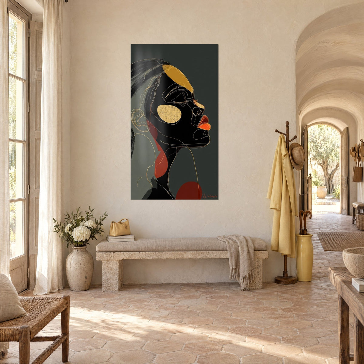 Wall art silhouette of a Black woman with golden features, orange lips and a red touch, hung in the entrance of a Provençal farmhouse