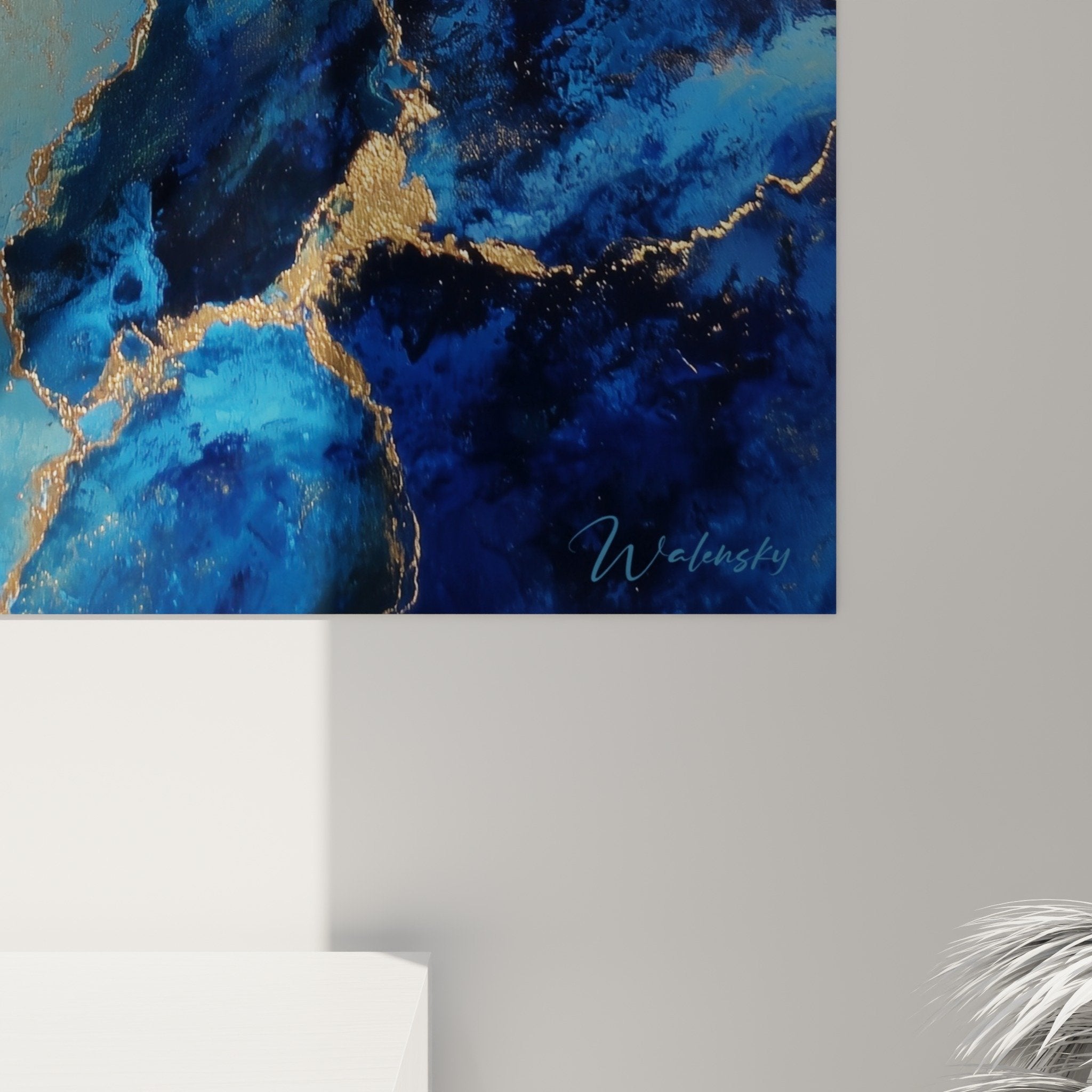 Full view of blue and gold wall art hanging on white wall contemporary interior decoration